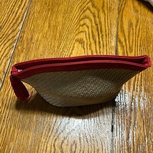 Yves Saint Laurent mini cosmetic bag. Ted trim and woven raffia.  Zip closure.